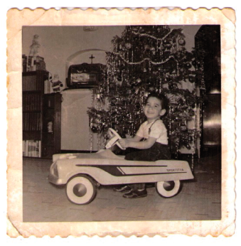 My first car, with its dazzling trim, in front of our well-trimmed tree. My outfit and hair are also in good trim.